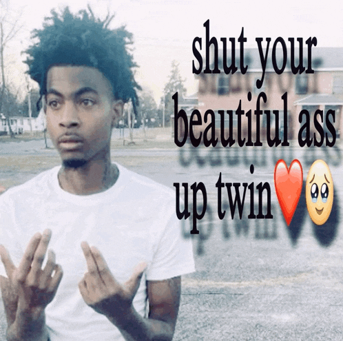 a young man giving the middle finger next to a sign that says " shut your beautiful ass up twin "