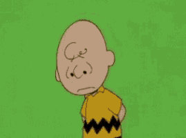 a cartoon character named charlie brown is standing on a green background with a sad look on his face .