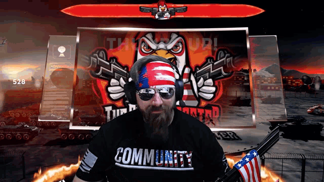 a man with a beard is wearing a community shirt