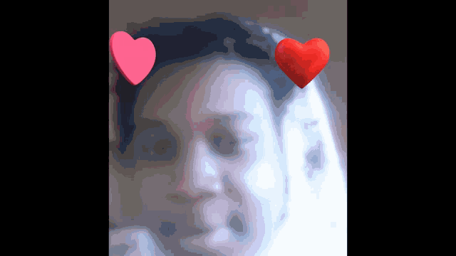 a close up of a woman 's face with two hearts on it