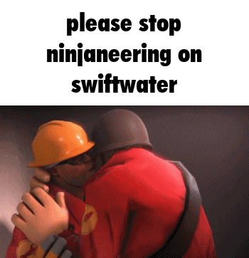 a man in a hard hat is kissing another man .