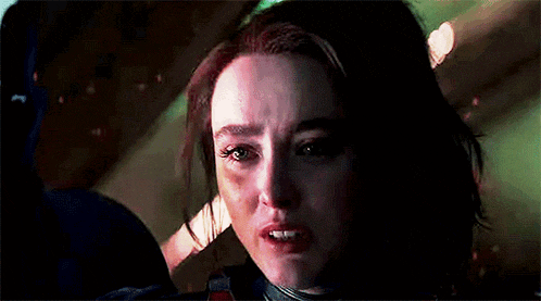 a close up of a woman 's face in a dark room .