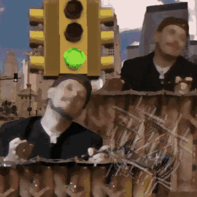 a yellow traffic light with a green light on