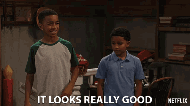 two boys standing next to each other with the caption " it looks really good " on the bottom