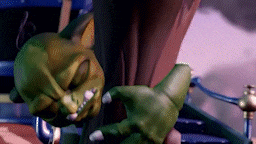 a green monster with sharp claws is sitting on a bench .