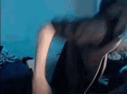 a person is standing in a room with a blue wall .