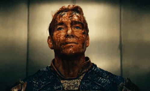 a man with blood on his face is looking up at the camera