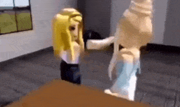 two girls are standing next to each other in a room .