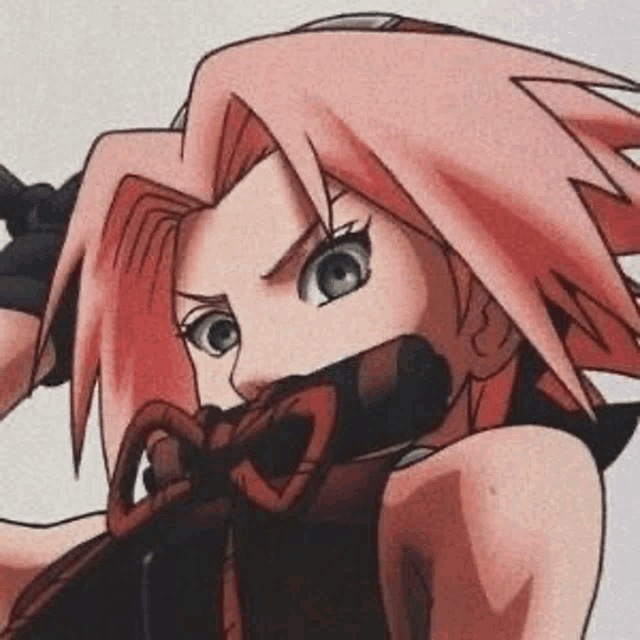 a close up of a cartoon character with pink hair holding a bow in her mouth .