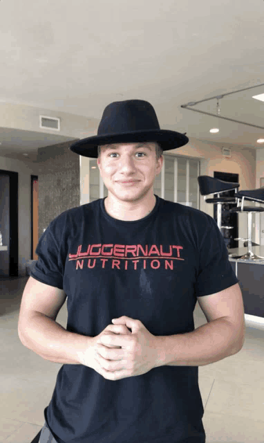 a man wearing a juggernaut nutrition shirt