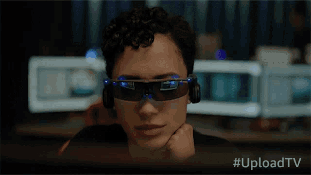 a close up of a person wearing a pair of glasses with the hashtag uploadtv on the bottom