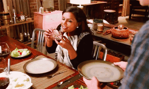 a woman is sitting at a table eating food