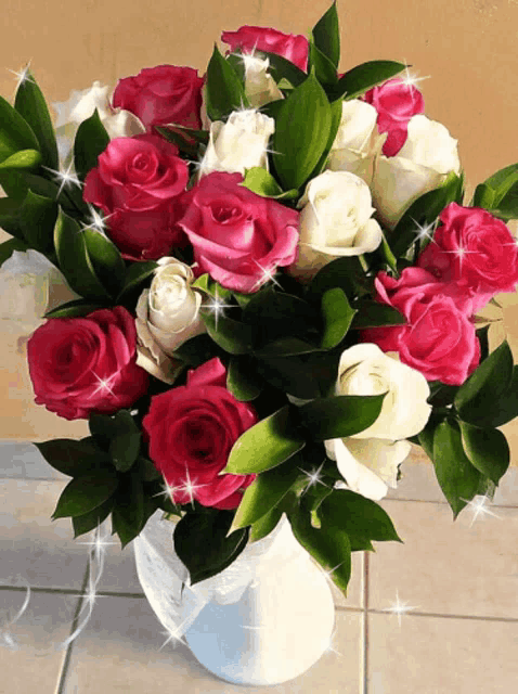 a bouquet of pink and white roses in a vase