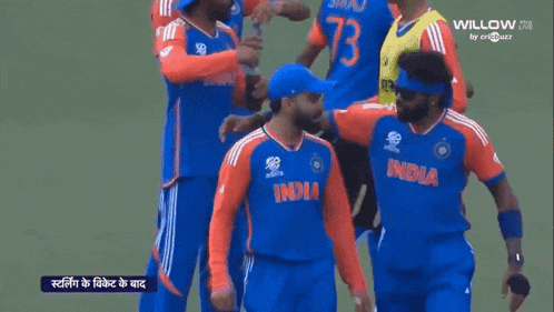 a group of cricket players are standing on a field and one of them is wearing an india jersey