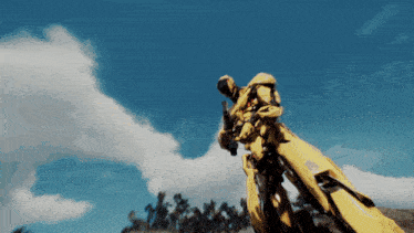 a man in a yellow suit is holding a rifle