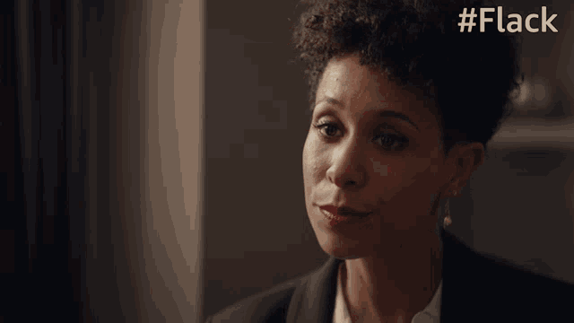 a woman says " you 're the boss " while wearing a black suit