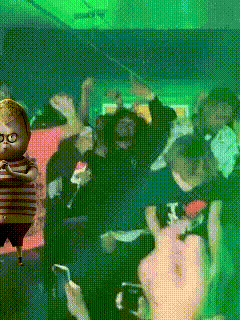a group of people are gathered in a dark room with a baby doll in the background