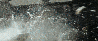 a black and white photo of a person splashing water