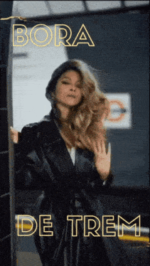 a woman in a black leather coat with bora de trem written on the bottom