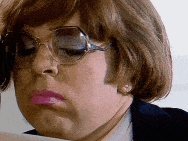 a close up of a woman 's face wearing sunglasses