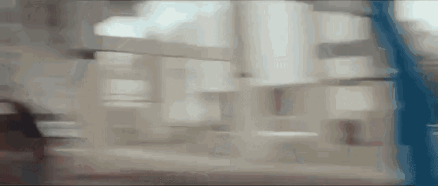 a blurry picture of a person walking down a staircase .
