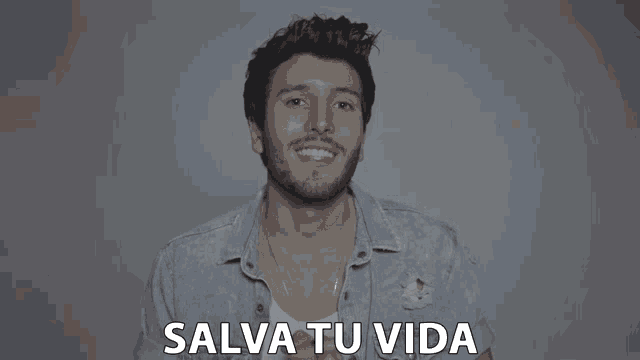 a man with a beard is smiling with the words salva tu vida written below him