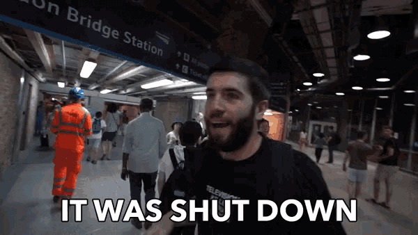 a man standing in front of a sign that says bridge station