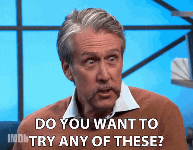 a man with a mustache is asking if you want to try any of these