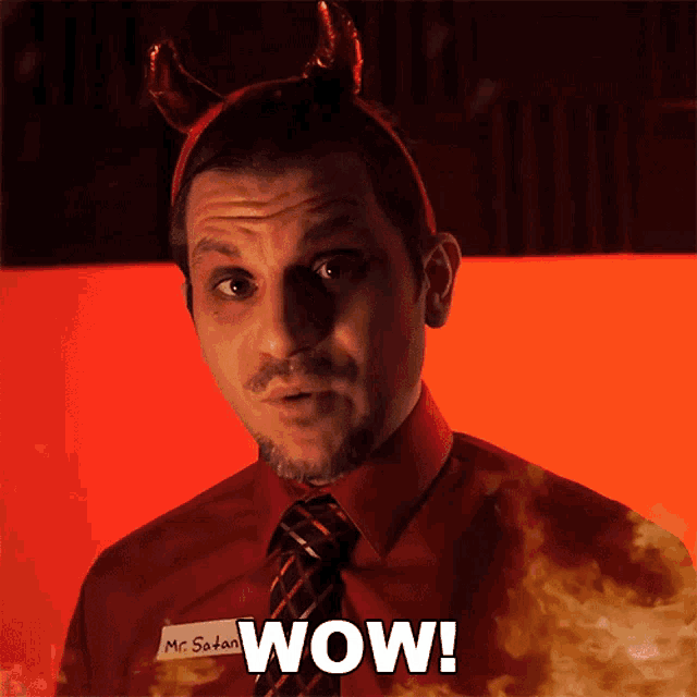 a man with devil horns and a name tag that says mr satan