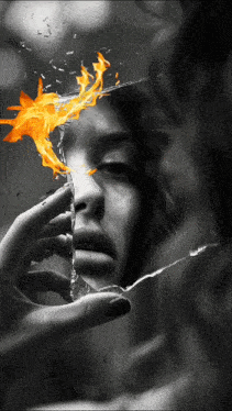 a black and white photo of a woman 's face with fire coming out of her eyes