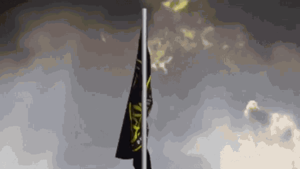 a black and yellow flag with the number 40 on it is waving in the wind