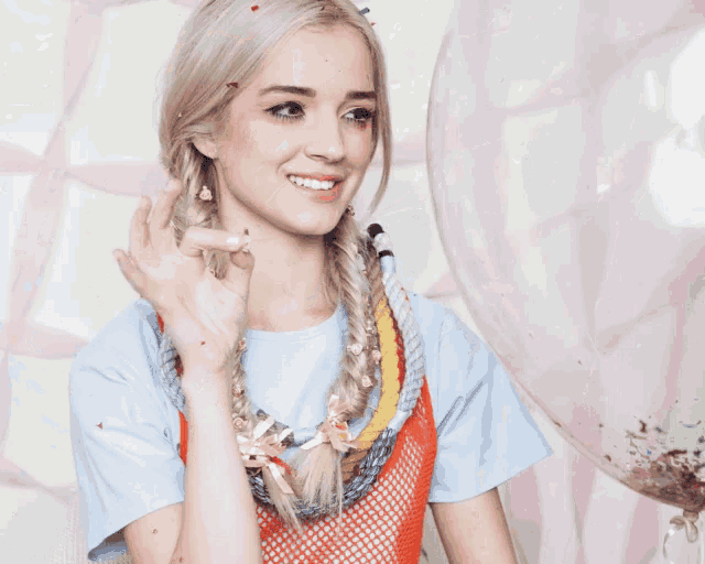 a woman is smiling with confetti falling on her