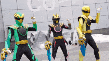 three power rangers are standing in front of a building that has the word co on it