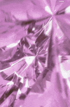 a close up of a purple background with a diamond shaped pattern