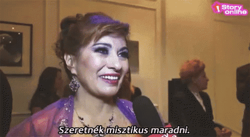 a woman in a purple dress is smiling in front of a sign that says " story online "
