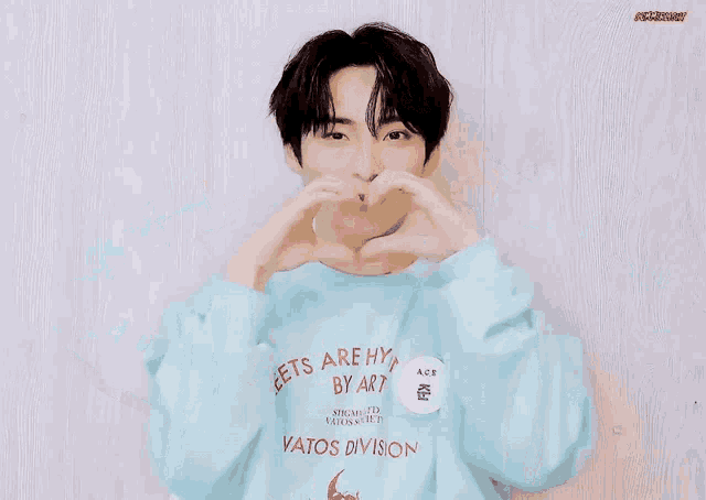 a young man wearing a blue sweatshirt that says streets are hypn by art