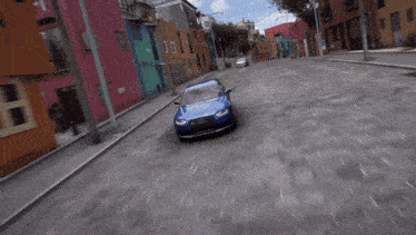 a blue audi car is driving down a brick road
