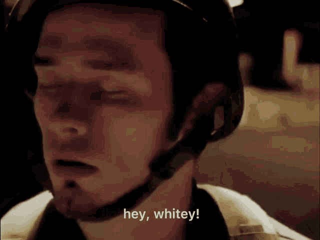 a man wearing a helmet says hey whitey with his eyes closed