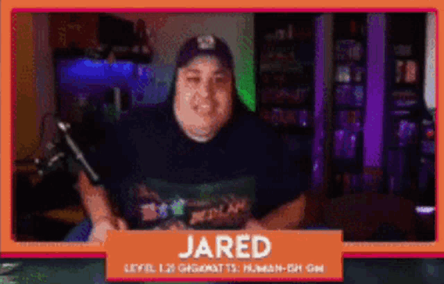 a man with the name jared on a sign in front of him