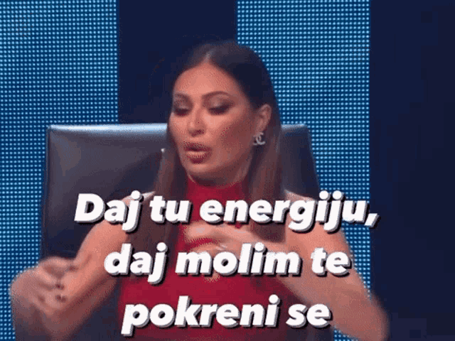 a woman in a red top is sitting in front of a computer screen with the words daj tu energiju daj molim te pokreni
