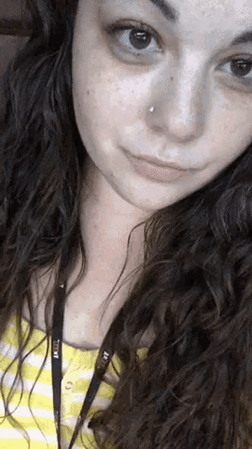 a close up of a woman 's face with a lanyard that says titan