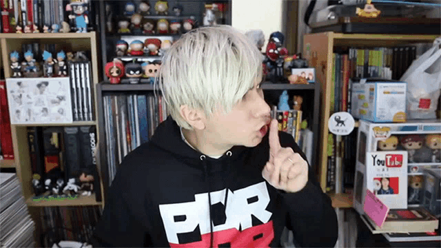 a man wearing a black hoodie with the letter p on it