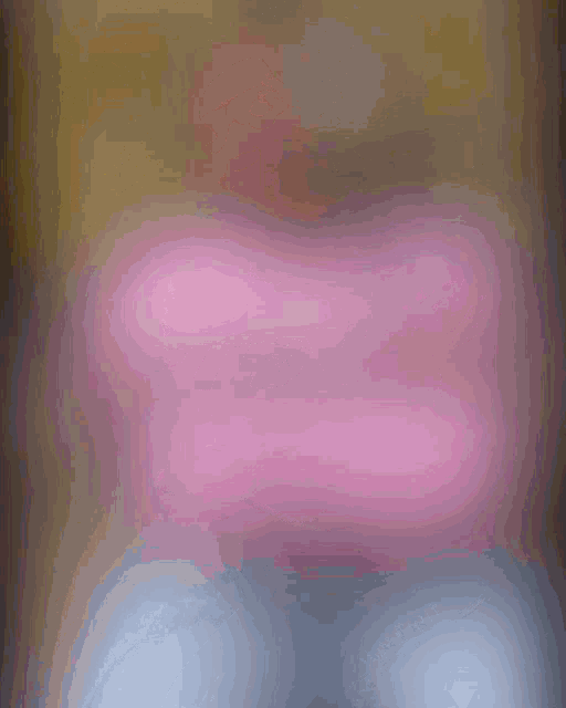 a blurred image of a woman in a pink shirt