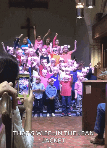 a woman taking a picture of a choir with the caption that 's wief ... in the jean jacket