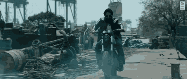 a man with a beard is riding a motorcycle down a road .