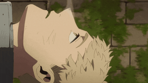 a man with a beard is laying down with his eyes closed in front of a wall