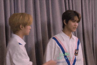 two young men are standing next to each other and one of them has a shirt that says a on it