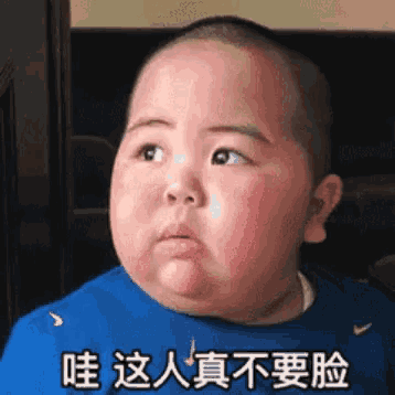 a baby in a blue shirt has chinese writing on his shirt