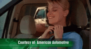 a woman is smiling while sitting in a car with the words courtesy of american automotive below her