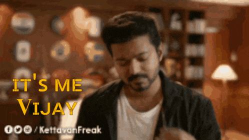a man with a beard says it 's me vijay in yellow letters